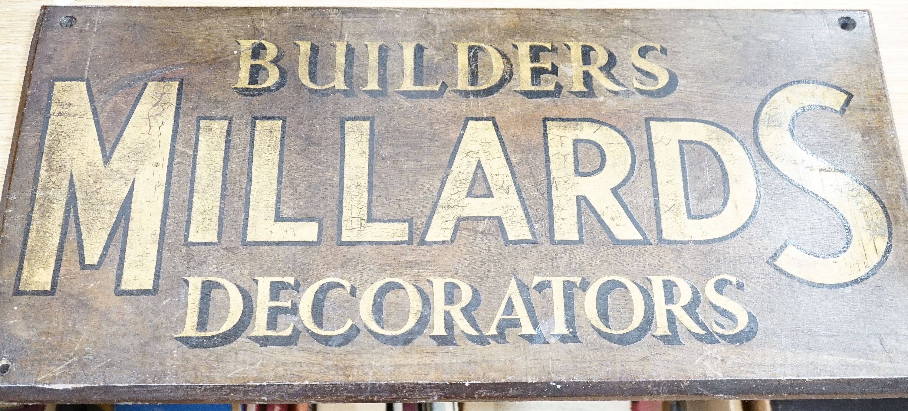 A painted wood advertising sign ‘MILLARDS BUILDERS DECORATORS’, pre war 33x67cm